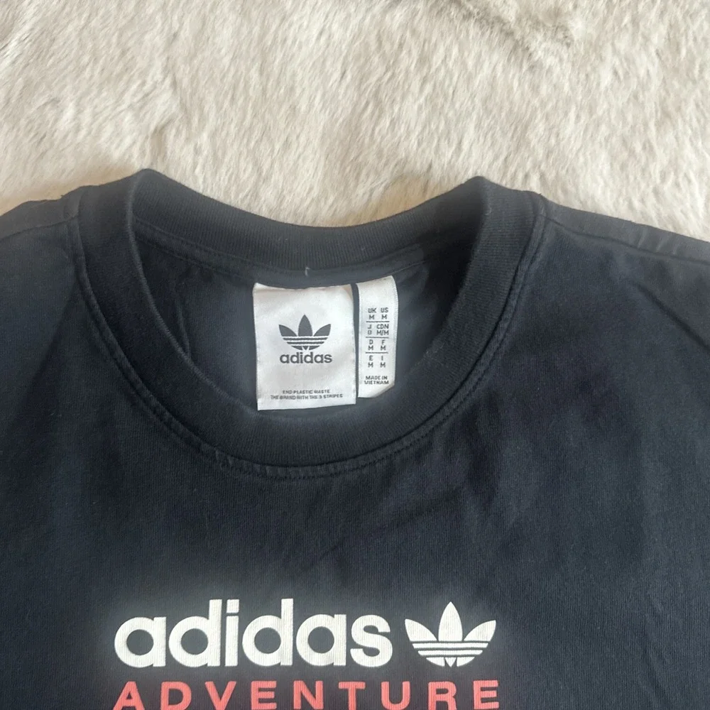 Adidas Adventure men's black graphic t-shirt‎ with Trefoil logo on chest.Size M